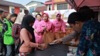 Anggota Polres Jember melayani pembeli dalam pasar murah. (Foto: Ambang)