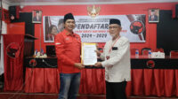 Perwakilan Ahmad Sudiono menunjukkan berkas pendaftaran calon kepala daerah di DPC PDI Perjuangan. (Foto: Abdus Syakur)